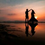 Silhouette of a couple dancing on the beach at sunset